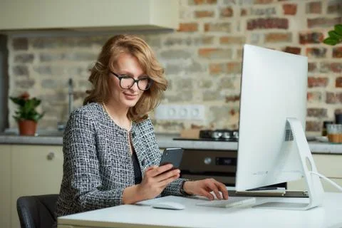A woman working on a desktop computer with her employees at a video conferenc Stock Photos
