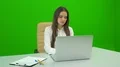 The woman working at the desktop on the green background 4k or 4k+ Resolution