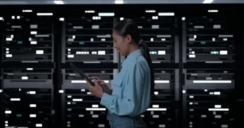 Woman Working With Digital Tablet In Server Room Database. Dark Server Room Stock Footage 248004732