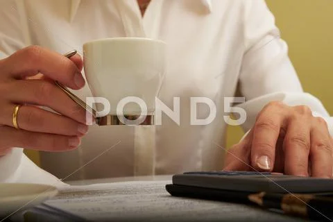 Woman working with documents with a cup of coffee Stock Photos