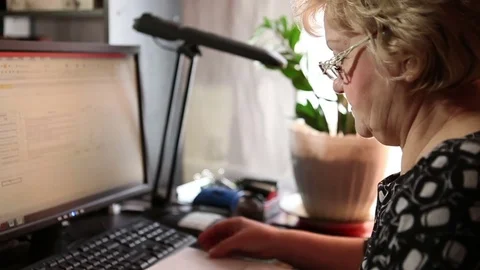 Woman working with documents sitting at computer Stock Footage 73447886