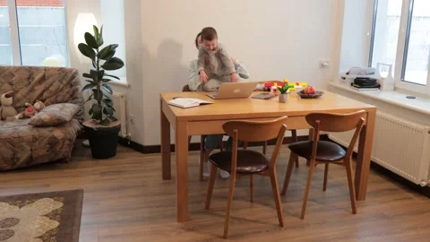 Woman working from home. Freelancer working at home with children playing around Stock Footage 147658853