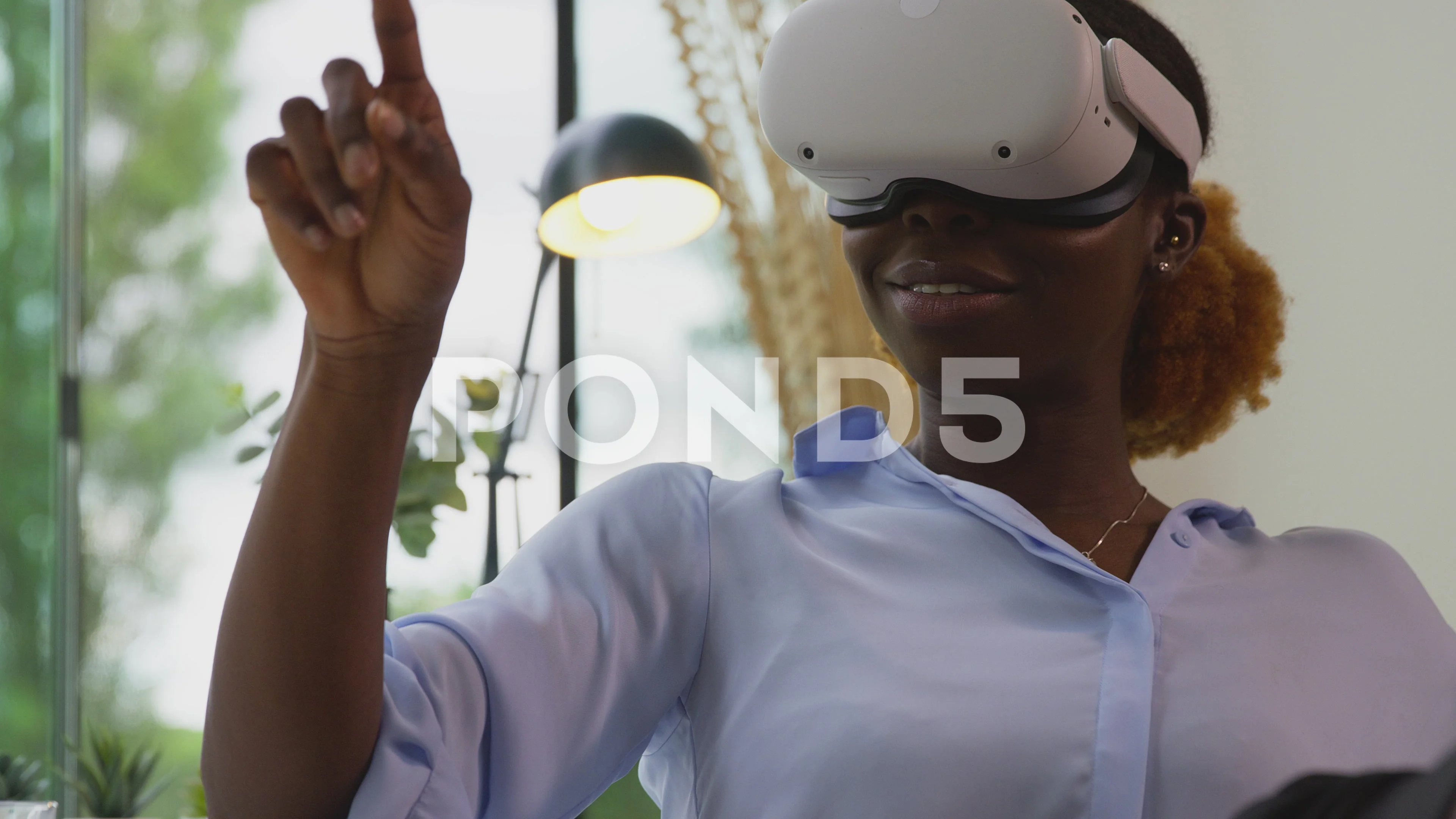 Woman Working From Home Office With Feet On Desk Wearing VR Headset  Interacting