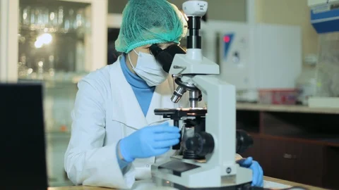 Woman working in a laboratory at the microscope Stock Footage 129111582