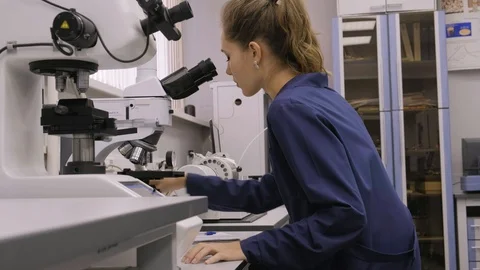 Woman Working In Laboratory With Microscope Stock Footage 130009559