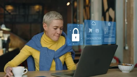 Woman working on laptop in cafe with data protection interface. VPN, Internet Stock Footage 279342849