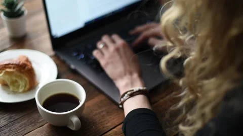 Woman working at laptop in cafe Stock Footage