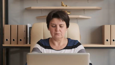 Woman working on laptop computer. Doing online job in home Stock Footage 134870078