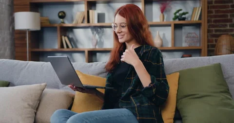 Woman working on laptop computer while video calling. Browsing lnternet, using Stock Footage 225531672