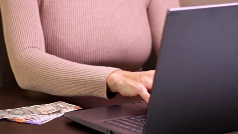 Woman is working with laptop computer while sitting at the table in home office. Stock Footage 299757602
