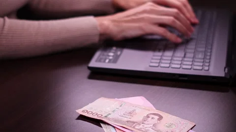 Woman is working with laptop computer while sitting at the table in home office. Stock Footage 299864901