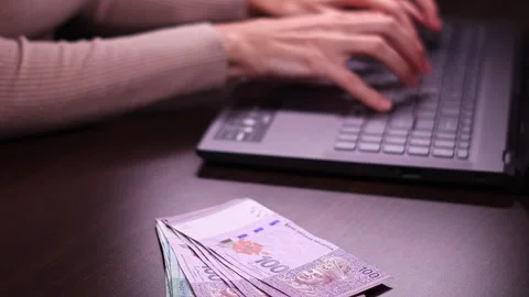 Woman is working with laptop computer while sitting at the table in home office. Stock Footage 299865063