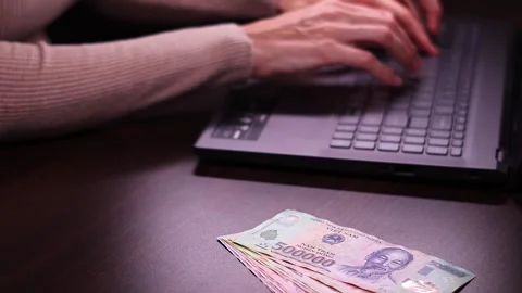 Woman is working with laptop computer while sitting at the table in home office. Stock Footage 299865664