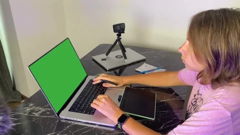 Woman working on laptop with graphics tablet Stock Footage 346743133