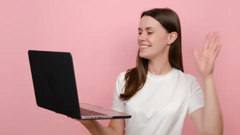 Woman working on laptop pc computer making video call greeting, waving hand Stock Footage 162849194