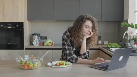 Woman Working On Laptop While Having Healthy Lunch In Cozy Kitchen Stock Footage 311282705