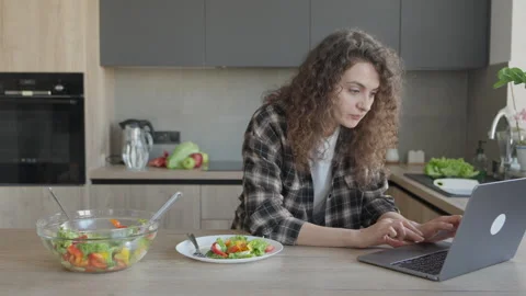 Woman Working On Laptop While Having Healthy Salad Lunch At Home Stock Footage 344698383