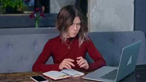 Woman working with the notebook at the table Stock Footage 166429874