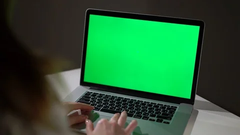 Woman working or using laptop computer with green screen chromakey display Stock Footage 129179765