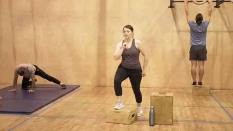 Woman working out doing box step ups in gym Video stock 221037150