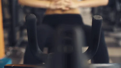 Woman working out on a exercise machine at the gym Stock Footage 128572666
