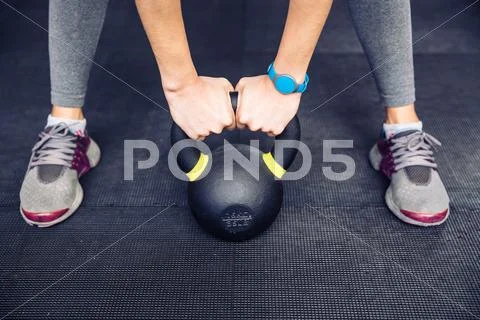 Woman working out with kettle ball Stock Photos