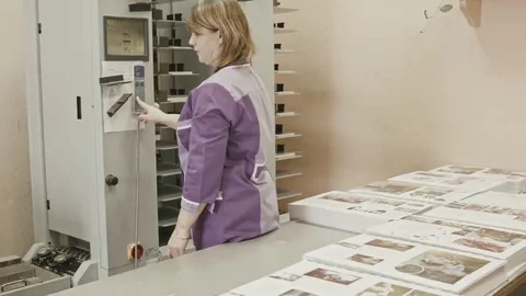 Woman working on polygraph folder machine in printing house - push the button Stock Footage 69126516
