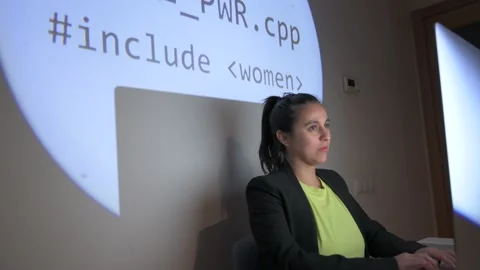 Woman working on programming code with girl power projection. Stock Footage 169823047