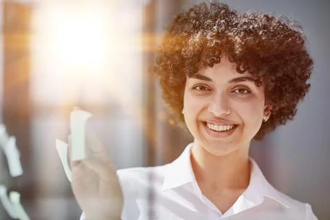 Woman working on project plan using sticky papers notes on glass Stock Photos