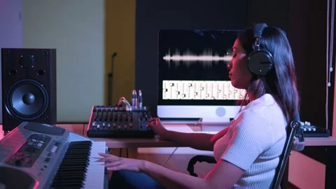 Woman working in the recording studio with computer and mixer creating music Stock Footage 149056105