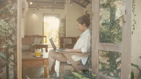 A Woman Working Remotely in a Comfortable and Cozy Indoor Space with a Relaxing Stock Footage 280848633