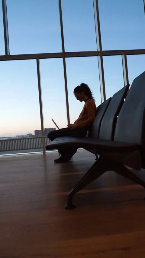 Woman working remotely with laptop while waiting for her plane to depart at.. Stock Footage 276477992