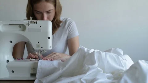 Woman working on the sewing machine Stock Footage 79646376