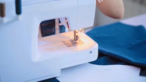 The woman working with a sewing machine on the table Stock Footage 107652970
