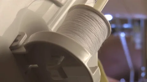 Woman working on sewing machine, the thread goes from the spool Video stock 81086894