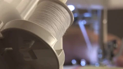 Woman working on sewing machine, the thread goes from the spool, the translation Video stock 81087070