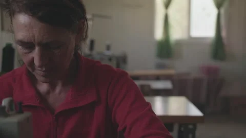 Woman working at a sewing machine in workshop Stock Footage 275076226