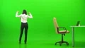 The woman working with at the table and phones on the green background 4k or 4k+ Resolution