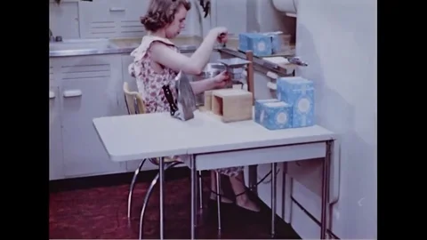 Woman working on the table near the pull-out board in kitchen - 1949 Vídeos de archivo 83834161