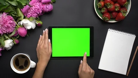 Woman working on tablet computer device with green screen. Beautiful white and Stock Footage 90436846