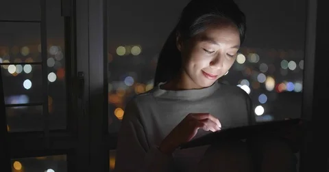 Woman working on tablet computer at night Stock Footage 84216096