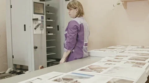 Woman working with touch screen on polygraph folder machine in printing house Stock Footage 69126563