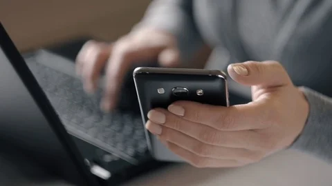 A Woman Is Working By Using A Laptop Computer And A Smartphone n Stock Footage 72505769