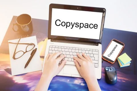 A woman is working by using a laptop computer and smartphone. Hand typing on  Stock Photos