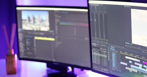 Woman working on a video editor software with two screens Stock Footage 159106176