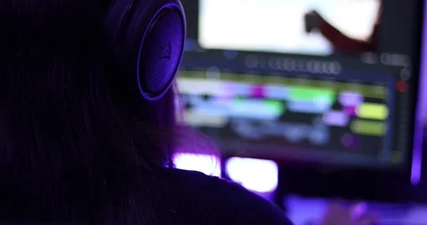 Woman working on a video editor software with two screens Stock Footage 159107006