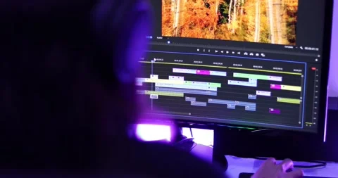 Woman working on a video editor software with two screens Stock Footage 159107618