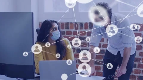 Woman working while man reaching laptop, sparking animated network map over tech Stock Footage 333968588
