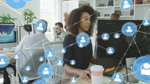 Woman working while node appearing by monitor expanding network overlay showing Stock Footage 328229416