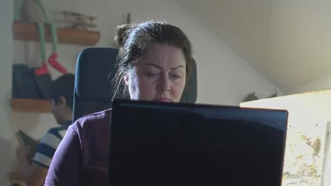 Woman works at home behind computer in background of baby appears Stock Footage 146650153